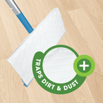 Mop head angled to show textured white wet mopping cloth and green 'traps dirt & dust' badge over a wood floor