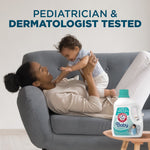 Woman lying on a couch lifting a baby with an Arm & Hammer Baby detergent bottle graphic and headline about pediatrician tested.