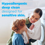 Mother and child near a washing machine with headline text about hypoallergenic deep clean for sensitive skin
