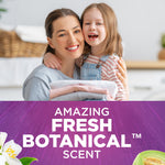 Smiling woman and child holding folded laundry above a purple panel reading Amazing Fresh Botanical Scent