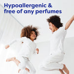 Mother and child jumping on a bed in white clothing with headline text 'Hypoallergenic & free of any perfumes'.