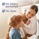 Lifestyle image of a smiling woman and child with a towel beside text highlighting no heavy perfumes and no dyes.