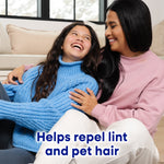 Smiling woman and girl seated together with overlay text 'Helps repel lint and pet hair'