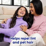 Smiling mother and daughter sitting together, daughter in a purple sweater, text about repelling lint and pet hair