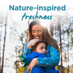 Woman embracing a child outdoors with sunlight and overlaid text reading “Nature-inspired freshness.”