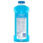 Rear label view of a translucent blue Mr. Clean multi-surface cleaner bottle showing ingredients and caution text