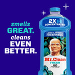 Mr. Clean 2X concentrated bottle on purple background with text 'smells GREAT. cleans EVEN BETTER.'