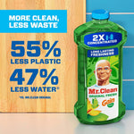 Mr. Clean Gain-scent bottle beside text callout '55% less plastic 47% less water' on wood and tile background