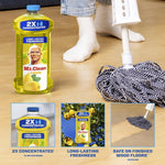 Lifestyle image showing Mr. Clean lemon bottle next to a mop and a person’s socked feet on a wood floor