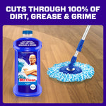 Mr. Clean Ocean bottle next to a blue mop head on a wood floor with bold claim text above