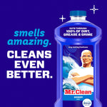 Blue Mr. Clean Ocean bottle on purple background with text reading smells amazing. cleans even better.
