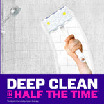 Hand holding Mr. Clean shower scrubber against tiled shower wall, showing foam and cleaned path with bold 'Deep Clean' text at bottom.