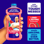 Illustrated hand holding a Mr. Clean watermelon-scent cleaner bottle with promotional callouts on a purple background.