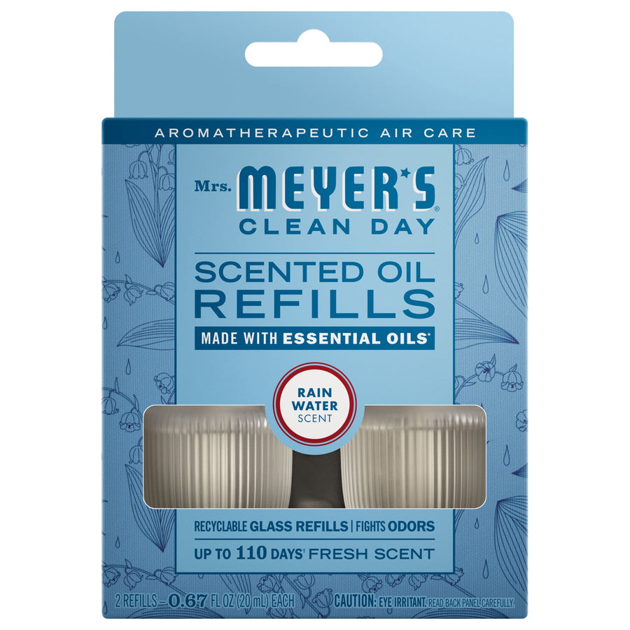 Blue Mrs. Meyer's Clean Day scented oil refills package with window showing two glass refill bottles and 'Rain Water' scent badge.