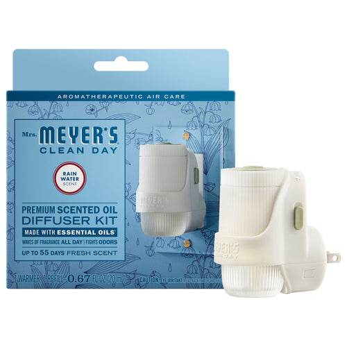 Mrs. Meyer's Rain Water scented oil plug-in kit box with the white plug-in warmer displayed in front on a white background.