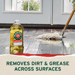 Murphy wood cleaner bottle next to a wet mop on a glossy wood floor in front of glass doors