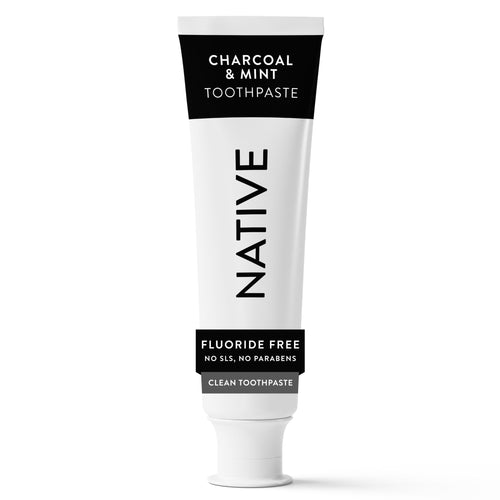 Native Charcoal & Mint toothpaste tube photographed upright on a white background showing black-and-white packaging and fluoride-free label.