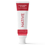 White tube of Native cinnamon & mint toothpaste with red label standing upright on white background