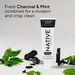 Native Charcoal & Mint toothpaste tube staged with charcoal pieces and mint leaves, with text describing the fresh charcoal and mint clean.