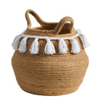 Nearly Natural round woven jute planter with white tassels and looped handles shown from slightly elevated angle