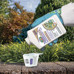 Gloved hand pouring Captain Jack's Neem MAX concentrate into a clear measuring cup in a garden setting