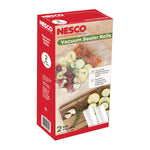 Single Nesco vacuum sealer rolls box with wood cutting board background and sealed food in clear plastic pouch