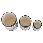 Top-down view of three empty cylindrical ceramic planters showing interior and patterned exteriors in small, medium, large.