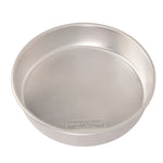Nordic Ware silver aluminum 10-inch round cake pan shown at a slight angle, interior visible