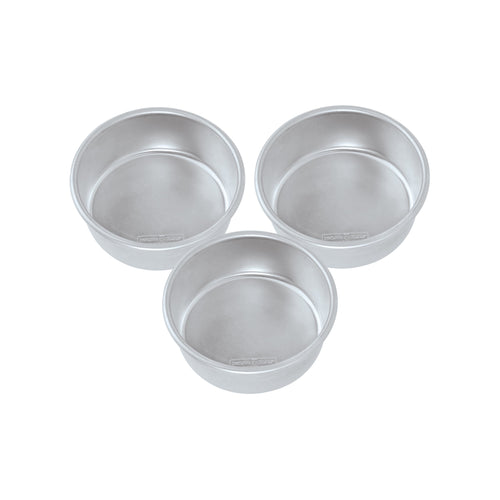 Three silver Nordic Ware natural aluminum round cake pans arranged on white background, brand stamp visible