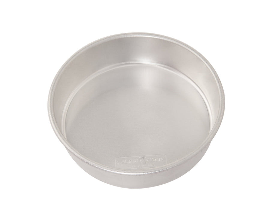 Nordic Ware aluminum 9-inch round cake pan photographed at an angle on white background, showing interior and rim.