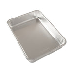 Nordic Ware aluminum rectangular baking pan angled view showing smooth interior and rim