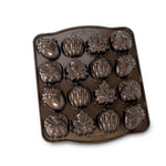 Nordic Ware nonstick metal cakelet pan with 16 autumn-shaped cavities in leaf, pumpkin and acorn designs