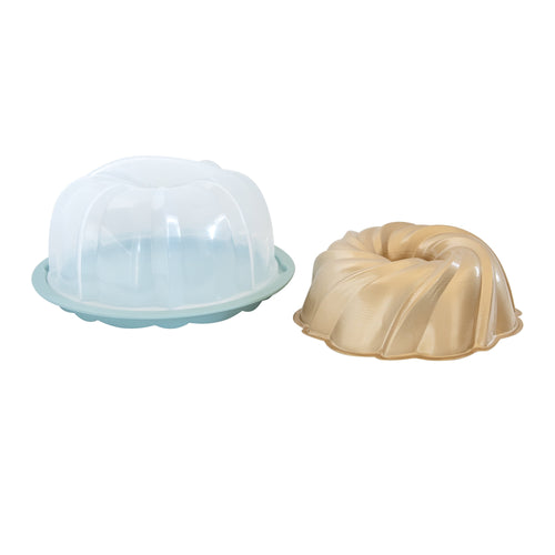 Clear plastic cake keeper lid with teal base beside a gold swirl bundt pan, product displayed on white background