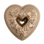 Nordic Ware metallic floral heart bundt pan, top-down view showing embossed roses and heart-shaped center tube.