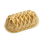 Nordic Ware gold-colored Jubilee loaf pan with geometric embossed decorative pattern, shown on white background.