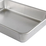 Close-up detail of a Nordic Ware aluminum pan corner and rolled rim showing finish and weld-free edge
