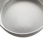 Close-up interior shot of a Nordic Ware cake pan showing embossed 'NORDIC WARE MADE IN THE USA' mark near the rim.