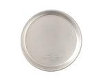 Top-down view of a Nordic Ware 9-inch aluminum round cake pan showing interior surface and embossed brand stamp.