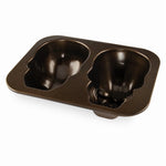 Angled studio shot of the Nordic Ware two-cavity skull cake pan showing the interior skull molds and smooth nonstick finish.