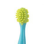 Top-detail view of a small blue handle with a green silicone brush head featuring short rounded nubs