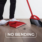 Red O-Cedar broom and dustpan on a wood floor demonstrating a no-bending step-on dustpan feature with a person nearby
