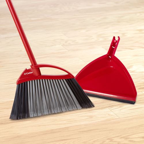 Red O-Cedar broom and matching step-on dustpan on a light wood floor, angled bristles visible