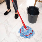 O-Cedar MicroTwist MAX mop in use on tile floor beside a black mop bucket and person’s legs