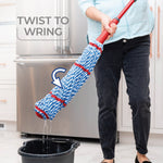 Person wringing O-Cedar MicroTwist MAX mop over a black bucket demonstrating twist-to-wring action