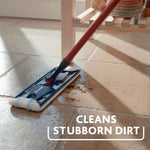 O-Cedar flat mop cleaning grout on a tiled floor, close-up of mop head removing stubborn dirt