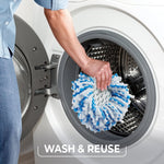 Hand placing O-Cedar mop head into front-loading washing machine drum with caption wash & reuse