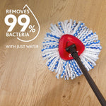 O-Cedar mop head on wood floor with red mop connector and graphic stating removes 99% bacteria with just water