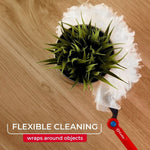 Top-down view of O-Cedar fluffy mop head wrapping around a potted faux plant on a wood surface