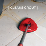 Red O-Cedar triangular scrub brush attached to a pole cleaning grout lines on tiled floor, labeled cleans grout.
