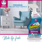 Staged living room scene with an OdoBan cotton breeze disinfectant spray bottle in foreground and armchair background